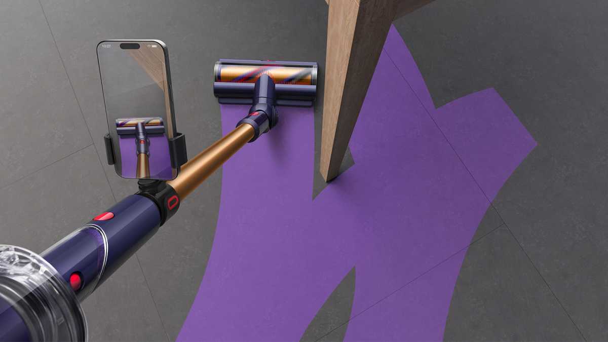 Dyson's CleanTrace, showing a phone clamped to the vacuum wand 