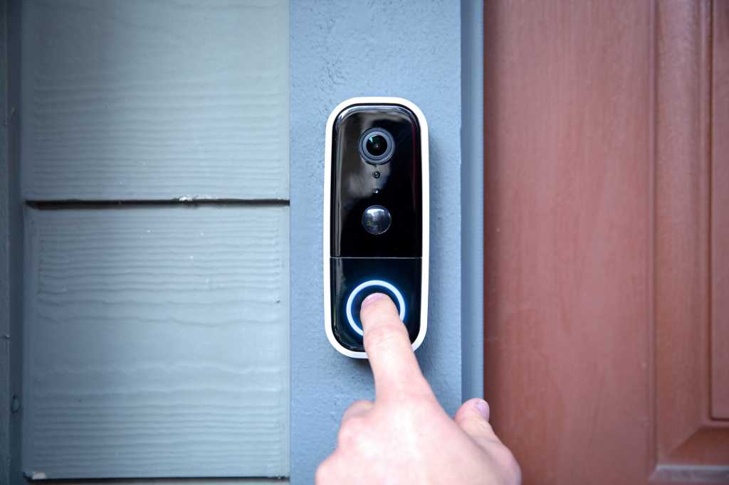 Pressing button of Adobe Video Doorbell